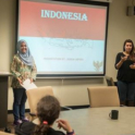 An Indonesian student stands in front of a Powerpoint that says Indonesia
