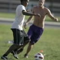 Two boys play soccer