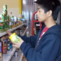 YEs alum looks at canned goods on a shelf