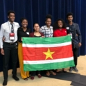 A Group Of Alumni Pose Holding Flag Of Suriname