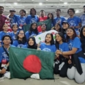 A Group Of Students Wearing Yes Shirt Pose With Bangladeshi Flags