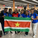 A Group Of Young People Holding Up The Flag For Suriname