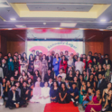 A Large Group Of People Wearing Formal Clothing Pose Together