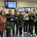 Group Of Students Posing Smiling Holding Roses