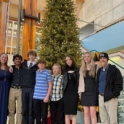 Host Family Posed In Front Of Christmas Tree With Exchange Student