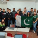 Large Group Of Students Pose In Classroom With Pakistani Flag For Iew