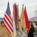 Mahnoor Standing In Front Of The American Flag And Other International Flags