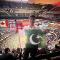 Student Holds Up Flag In Sports Arena