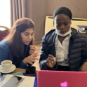 Joyce and Yumna working together in front of computer