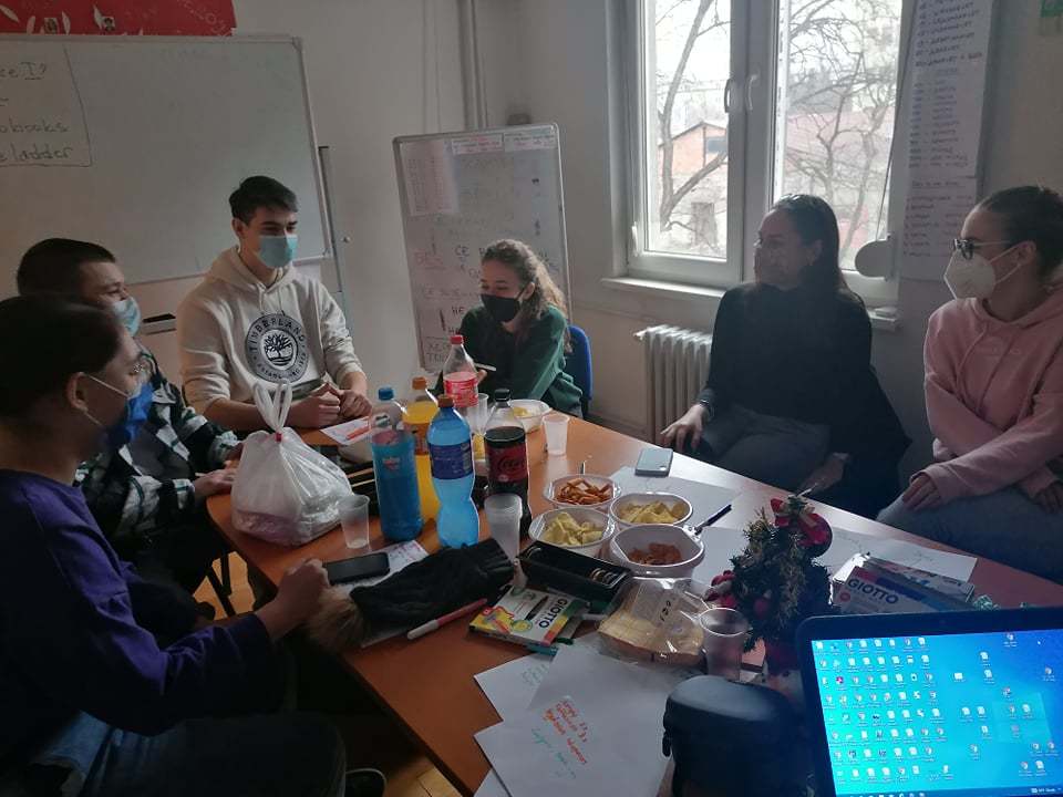 Six Macedonian YES alumni at conference table with food and drinks