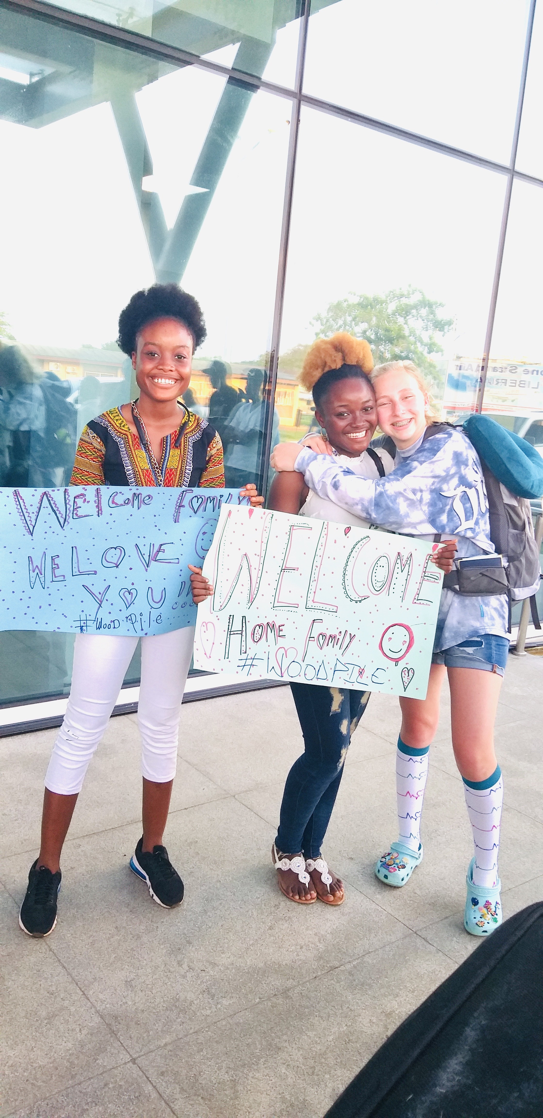 Antoinette greeting her host sister at the airport in Liberia