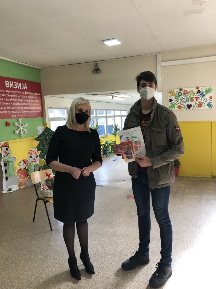 Two people standing with masks on