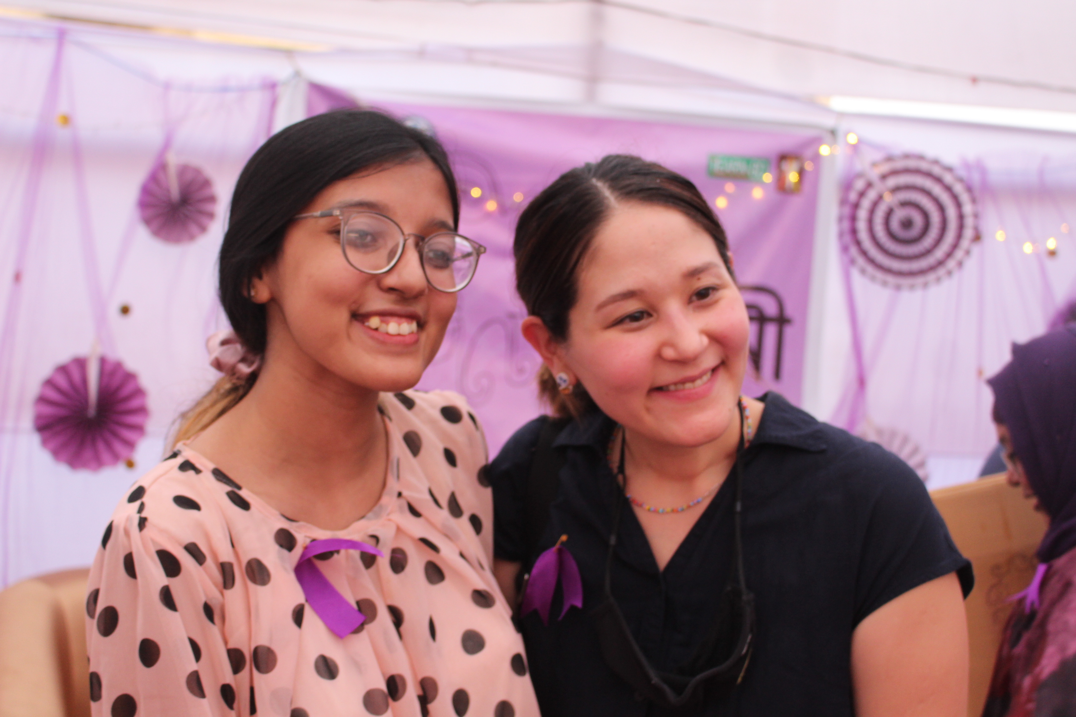 Nuzhat smiles during the event with anther woman