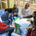 A Group Of Six Participants Sits Around A Table Taking Part In A Focused Group And One Of Them Is Writing On Paper 1 Highlight Photo