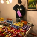 YES student Peter stand over a table full of prepackaged food