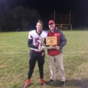 YES student football player holds trophy