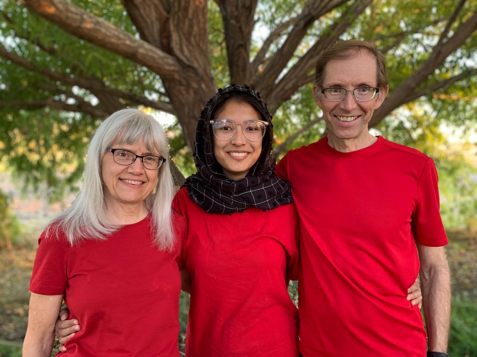YES student and her host family wear matching red shirts
