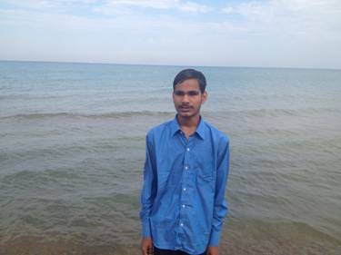 Ajit standing in front of the ocean