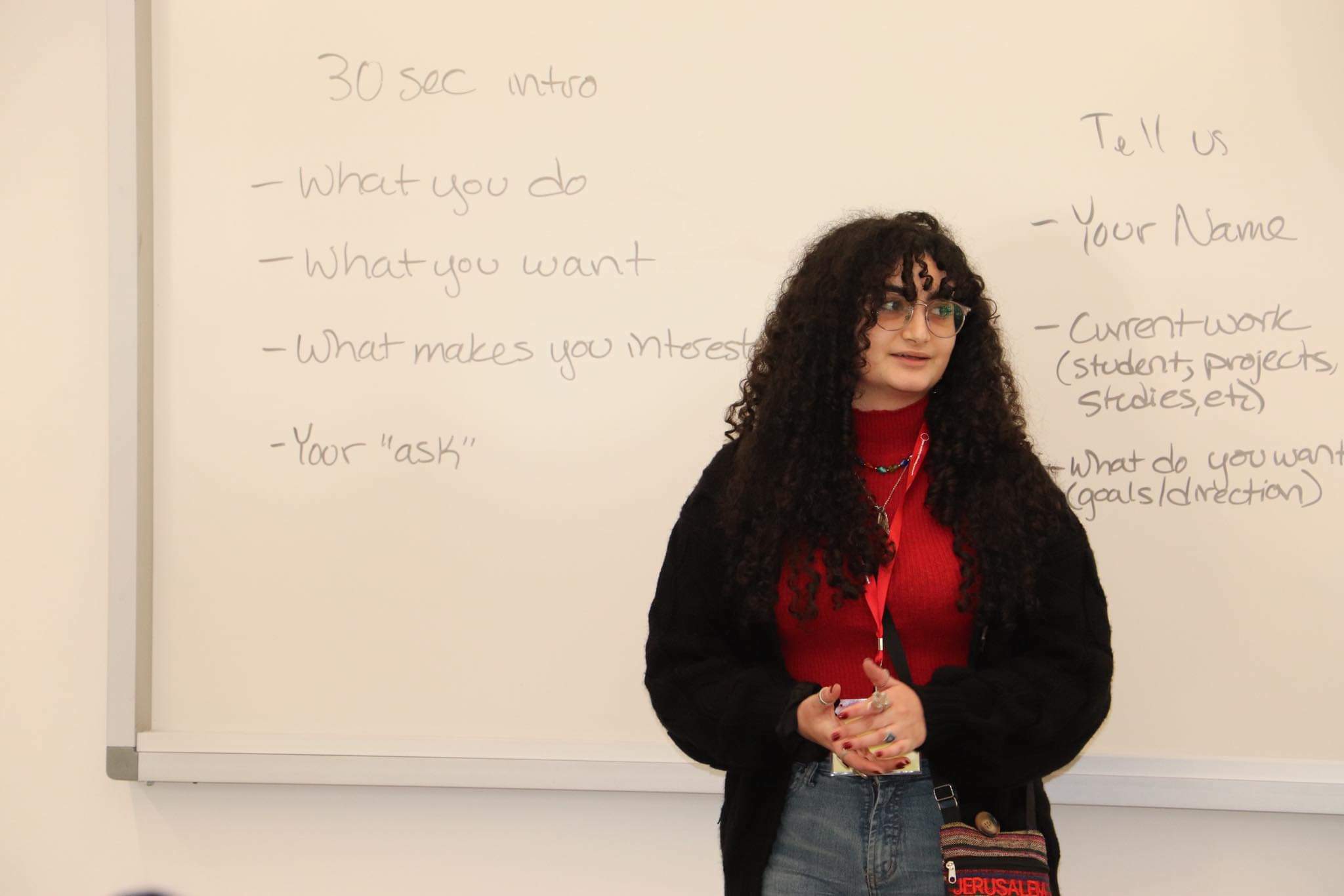 Dareen standing in front of a whiteboard
