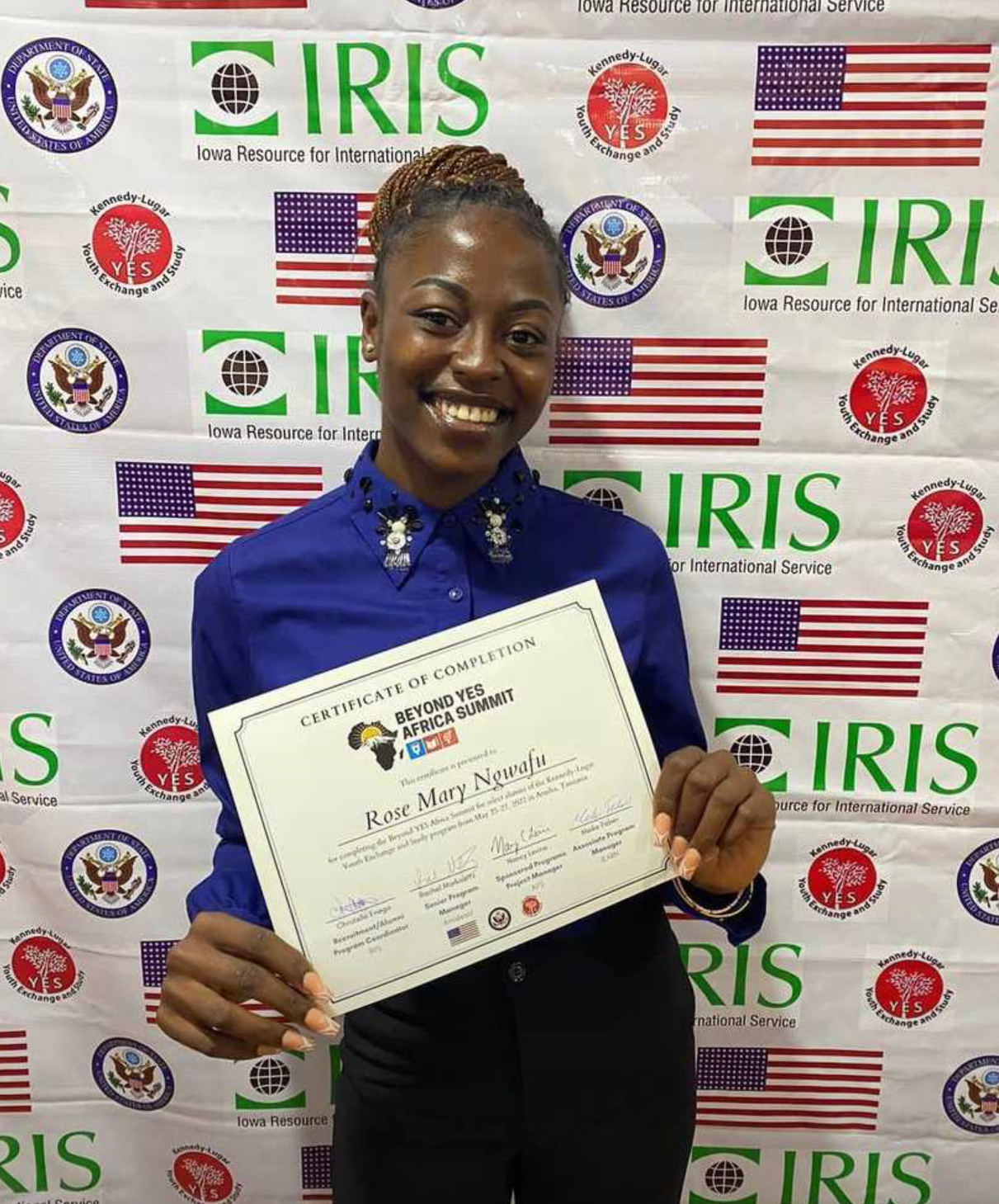 Rose Mary holding YES program certificate. 