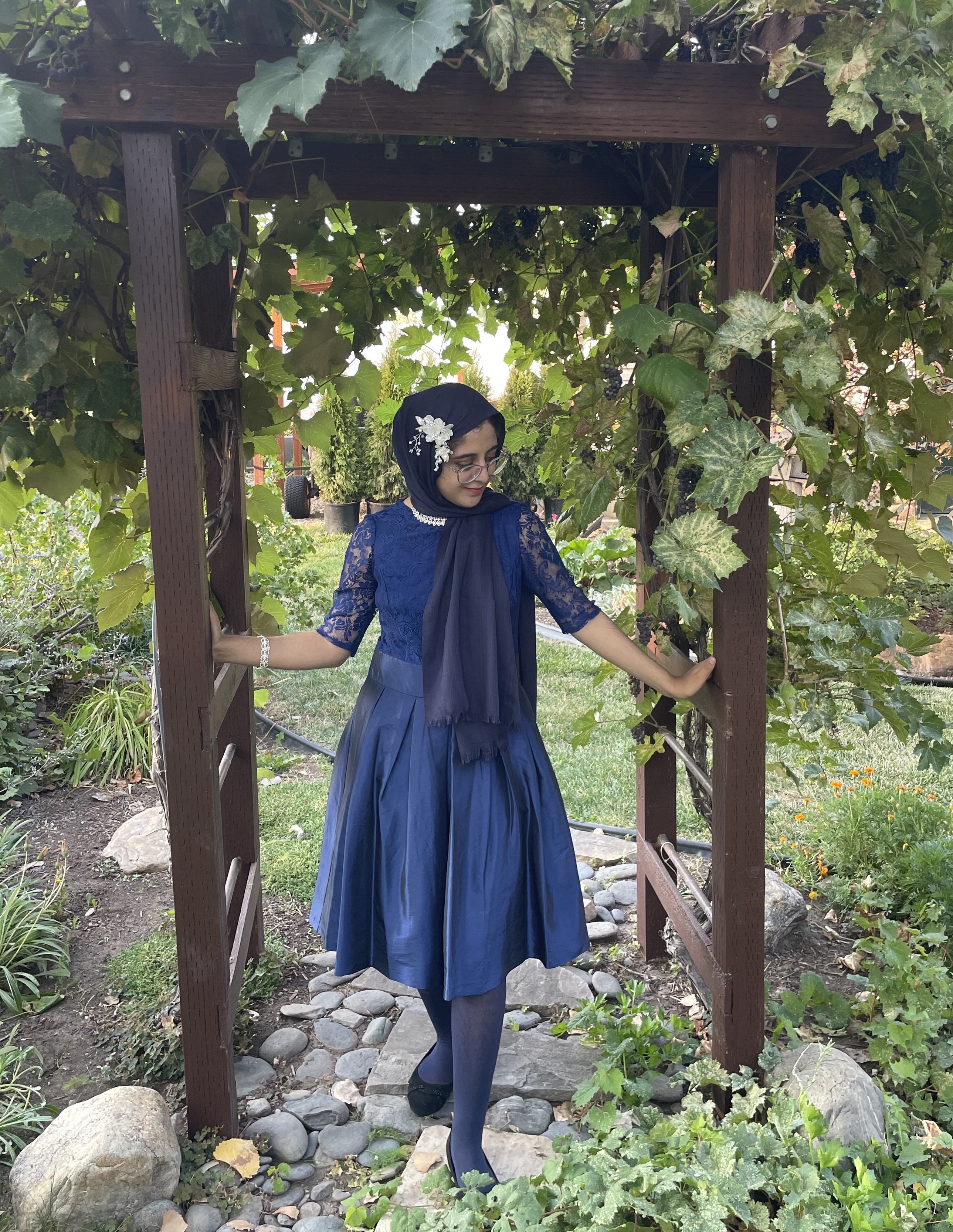 Mariam wearing her homecoming outfit for a photo outdoors. 