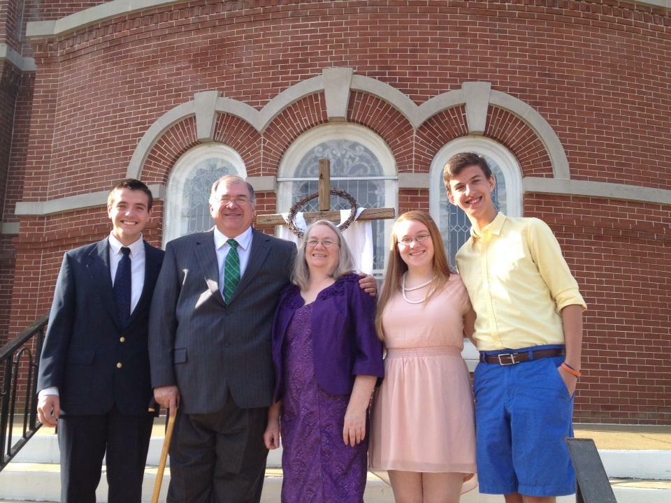 A Group Of People Dressed Up And Posing Outside Of A Church Smiling