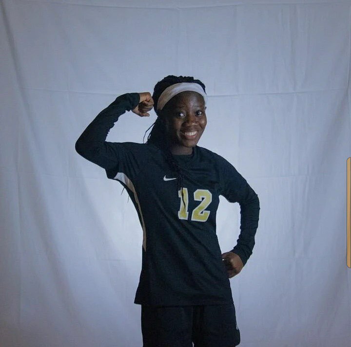 Aluma posing in soccer uniform