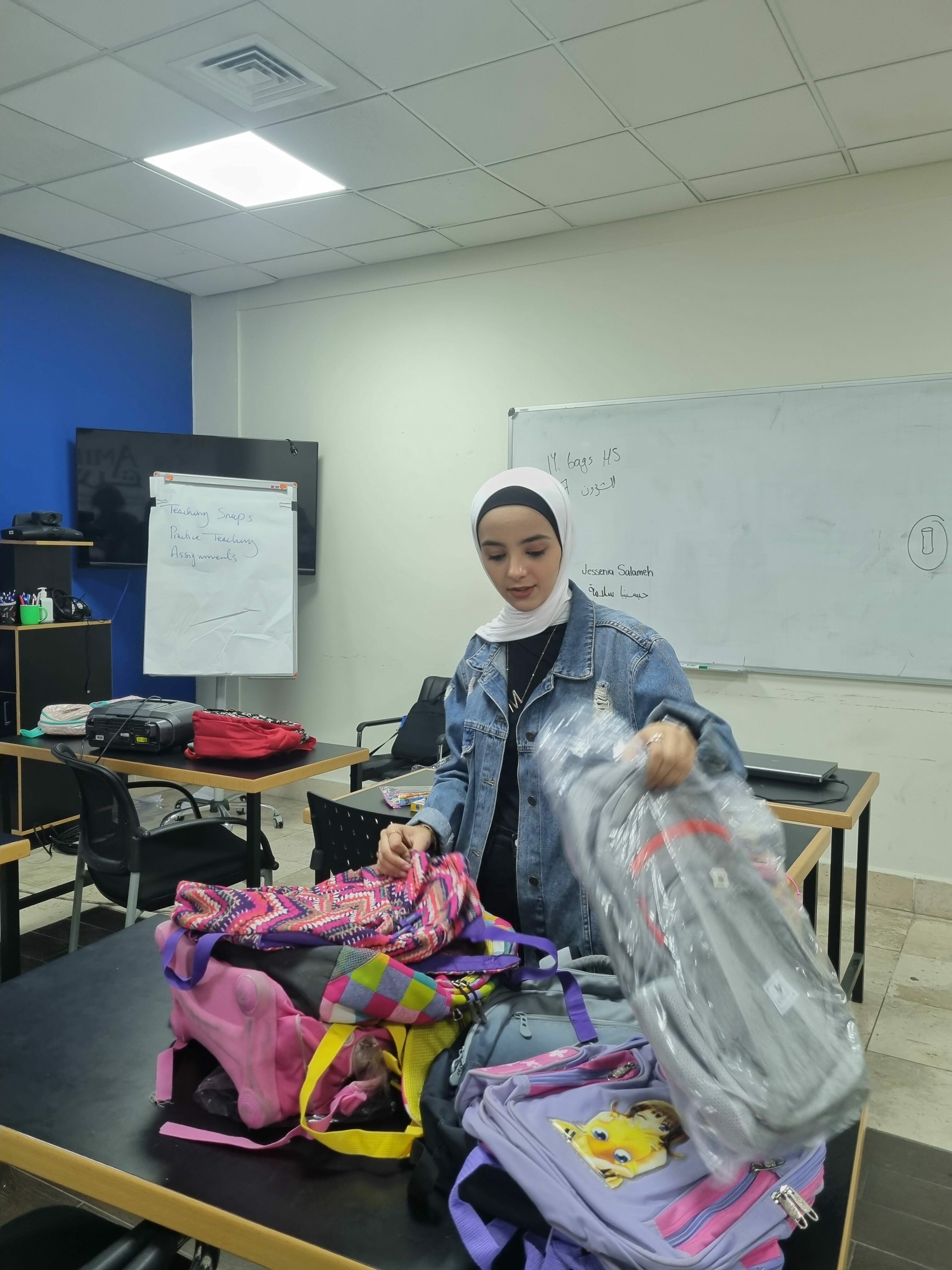 a female volunteer packs and sorts bags for donation
