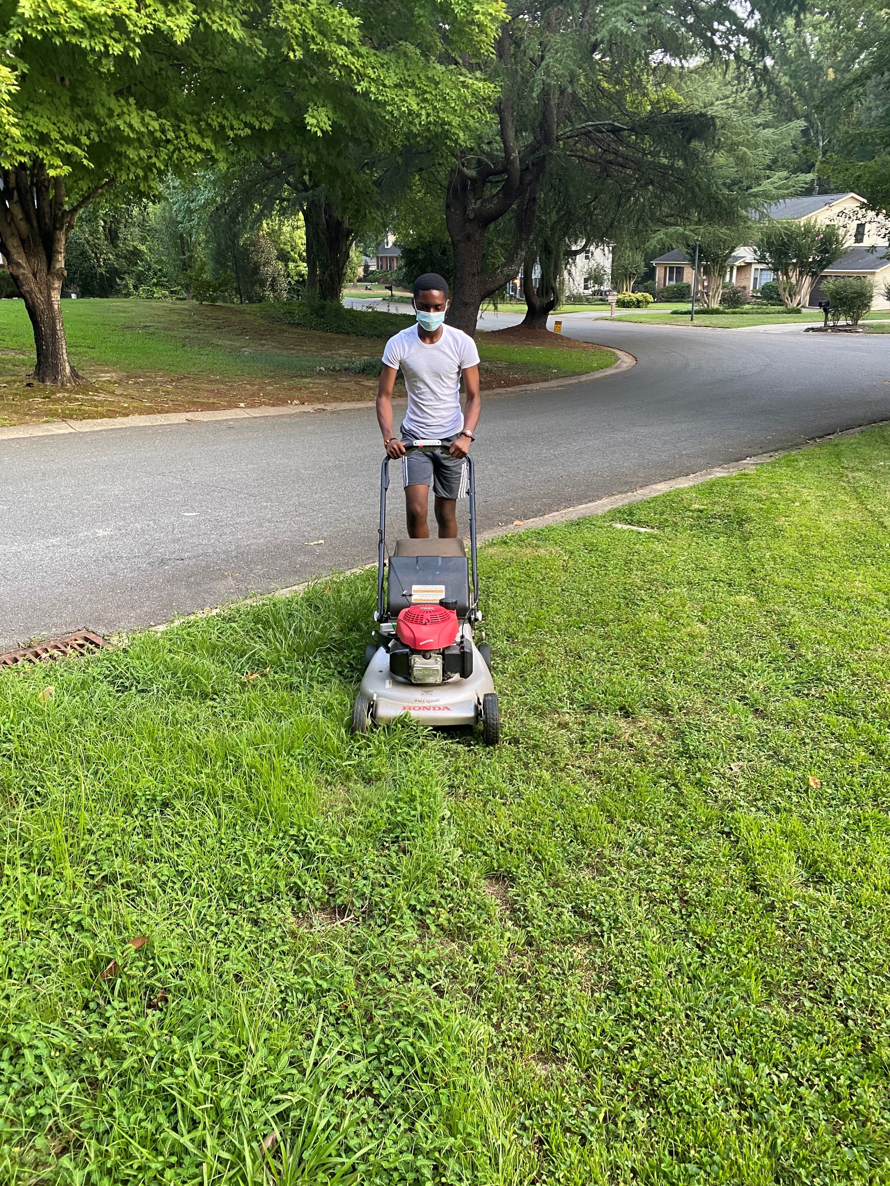 Omari mowing the lawn