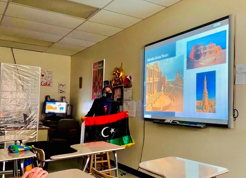 Libyan student holding a flag.