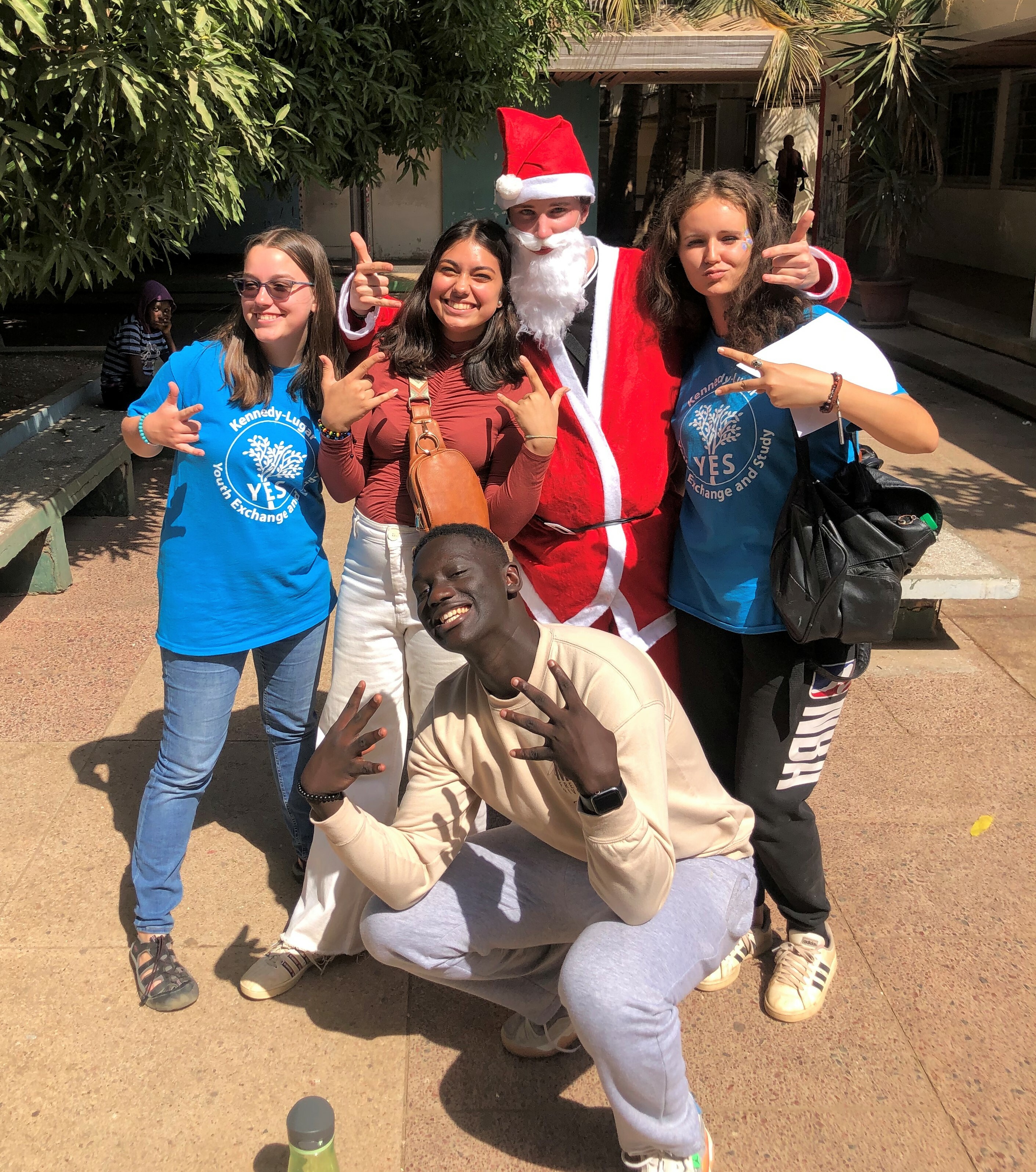 Four YES Abroad students (including one dressed as Santa) and one YES alumnus pose for the camera