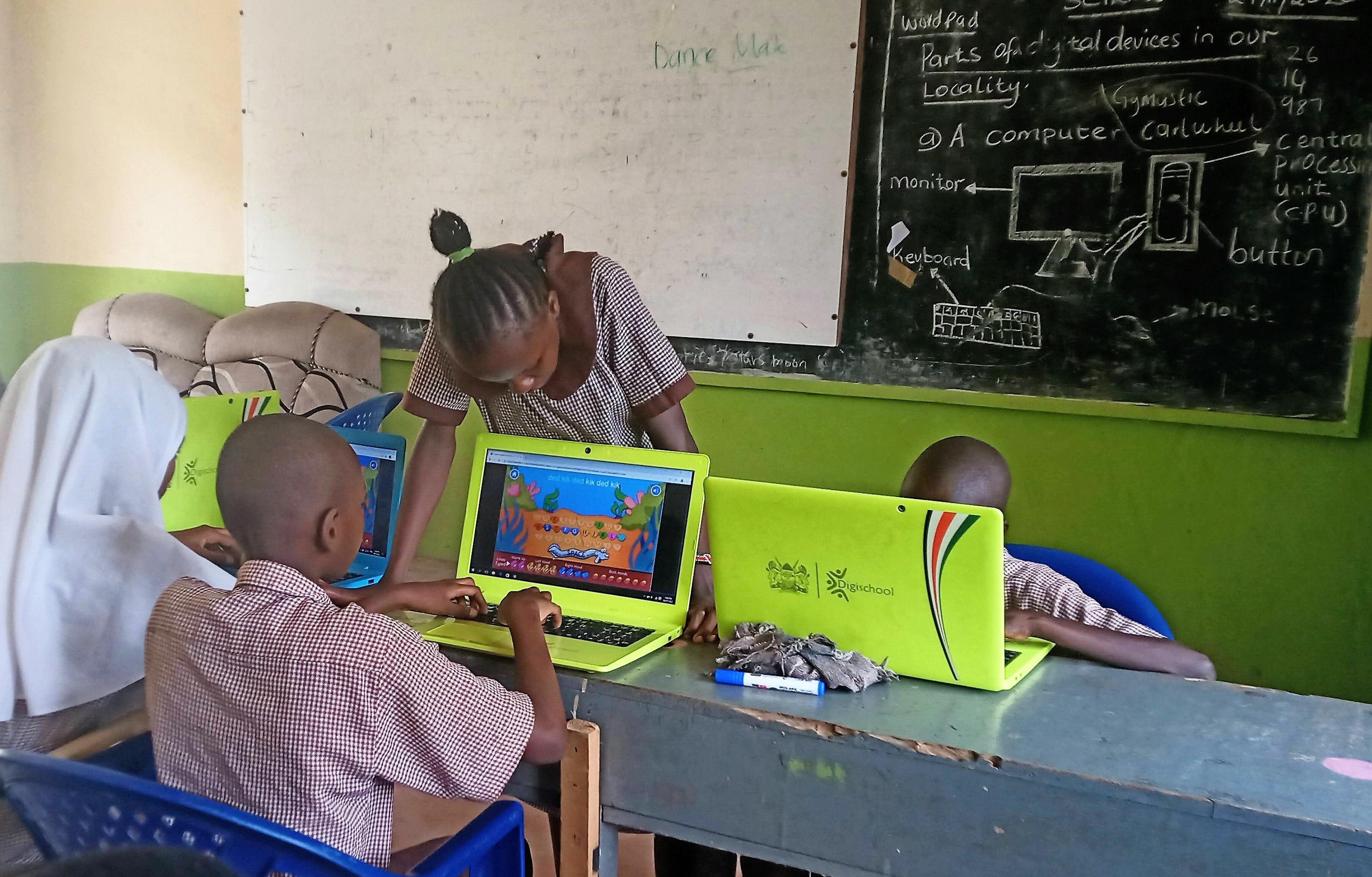 Four Children Doing Activities On Computers