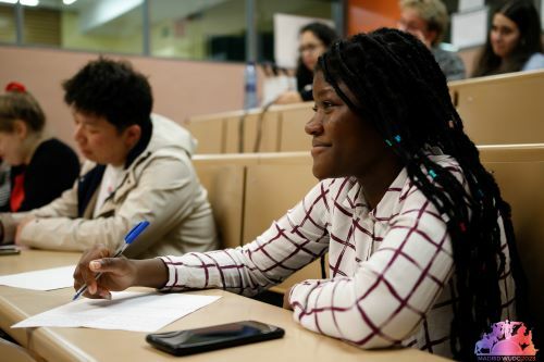 Ruth from Ghana sitting at a table with a panel of judges