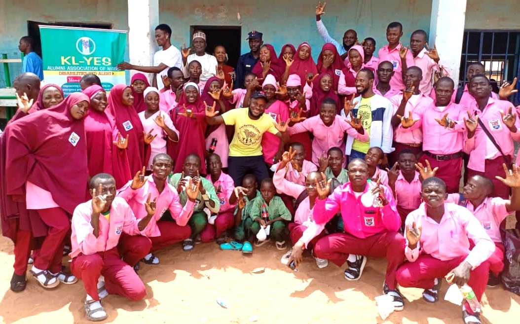 Group photo with participants showing the word LOVE in sign language