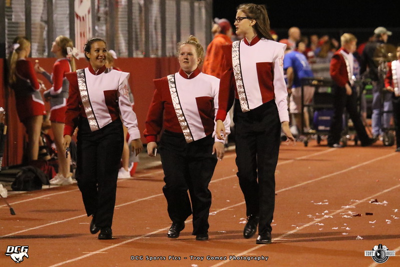 Hiba walking in marching band with two friends