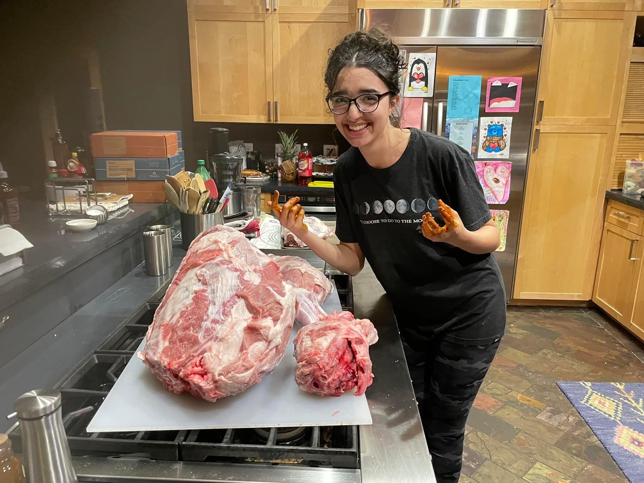 Hind poses with meat at a butcher shop
