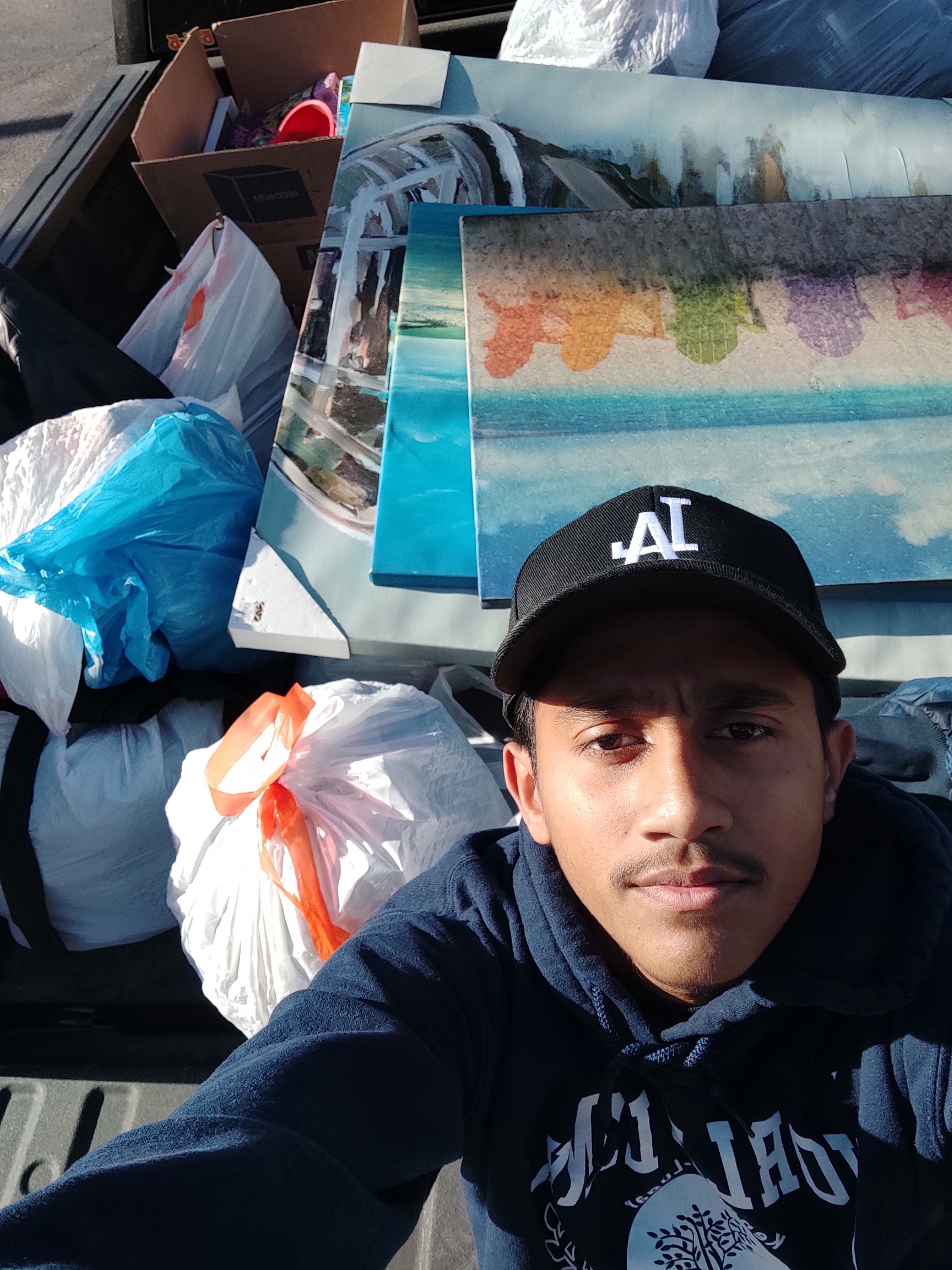Ashfaque taking a photo with the donations. 