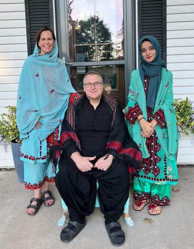 Sahar and host parents wearing traditional dresses from Pakistan. 
