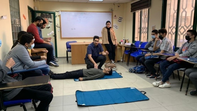 In A Classroom In Gaza Participants Are Watching A First Aid Demonstration  There Is A Dummy On The Floor