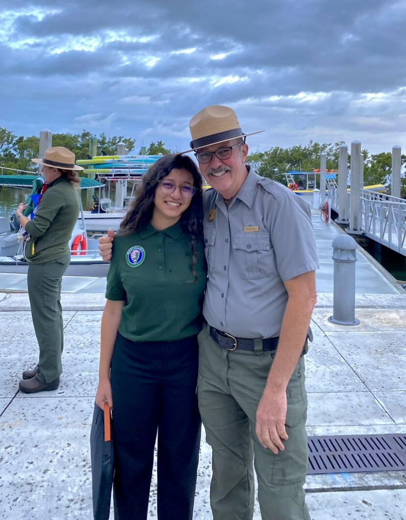 Isra And A Man In A National Park Service Uniform On A Dock