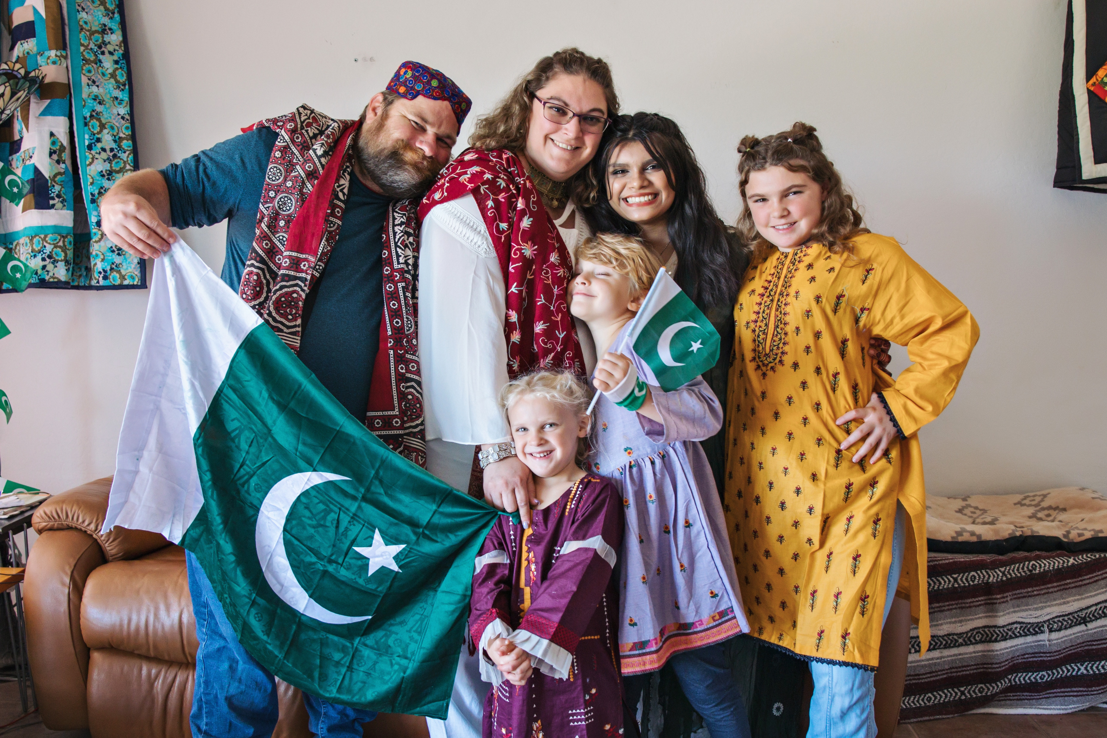 Kehkashan wither her host family holding Pakistani flags