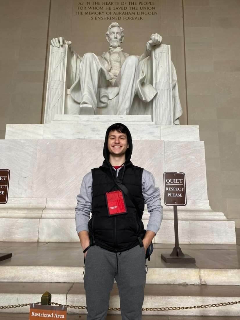 Maksim Stands In Front Of Lincoln Memorial