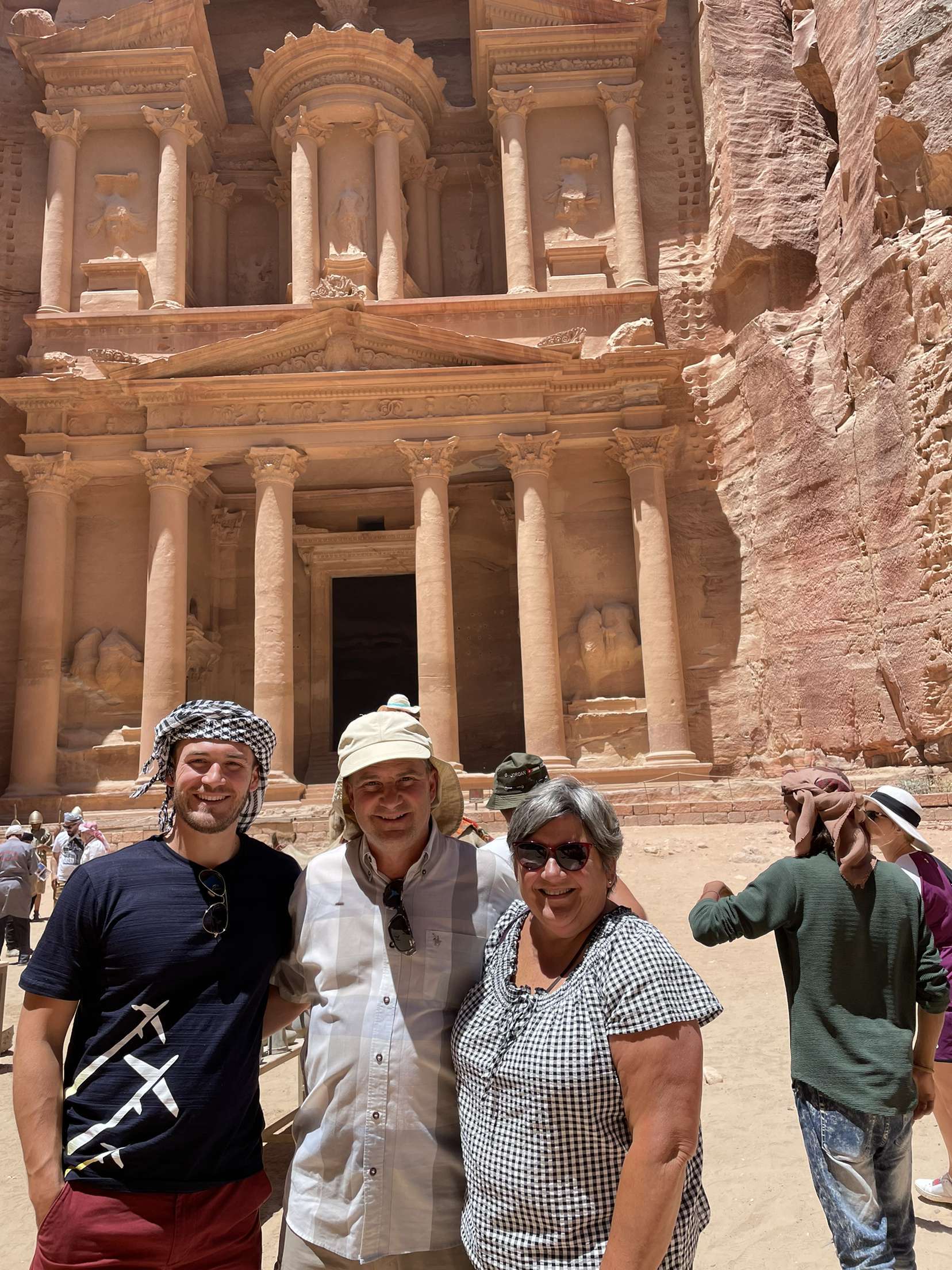 James and his parents posing together in Petra