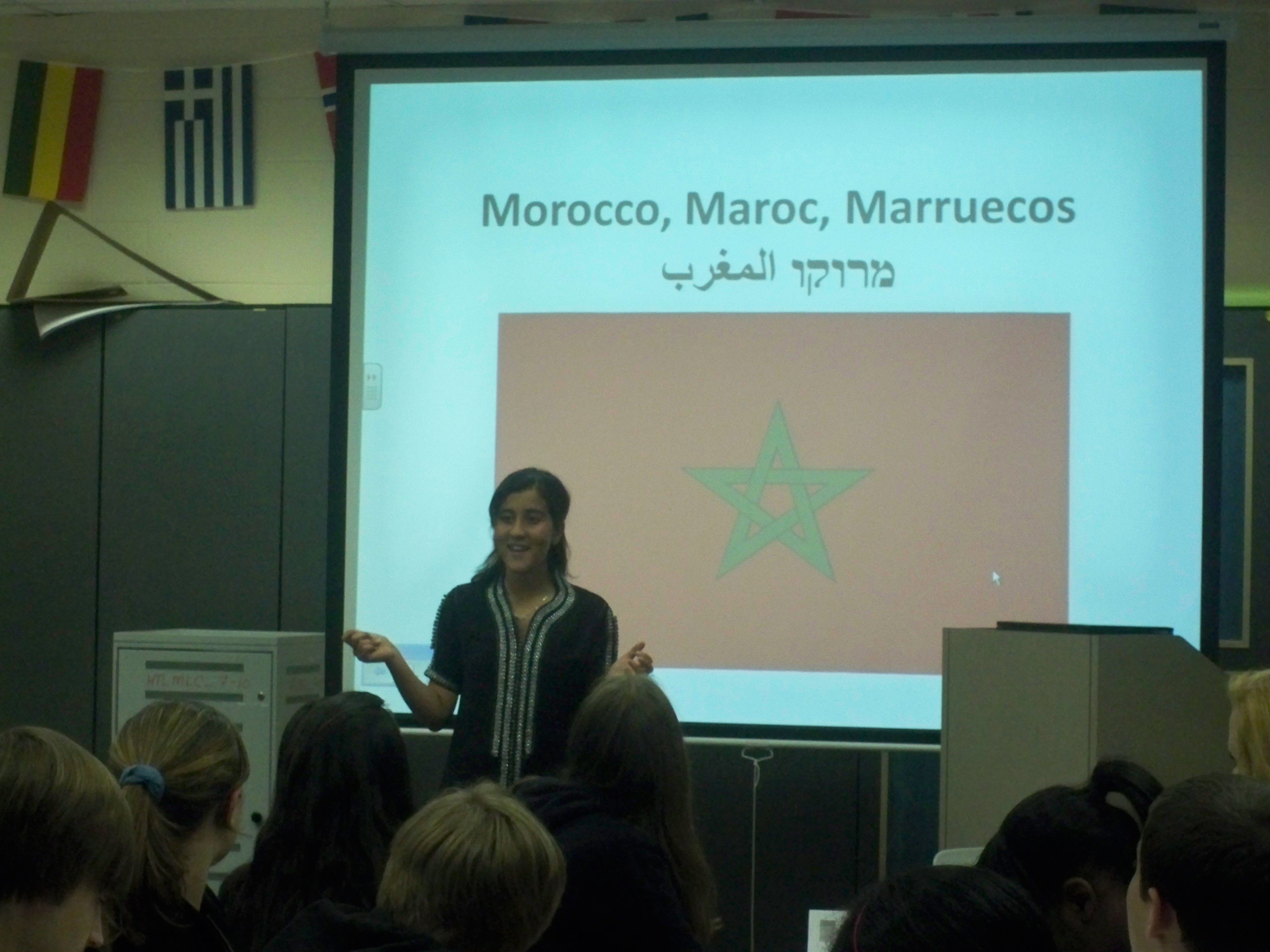 Oumaima presenting about Morocco in a classroom. 
