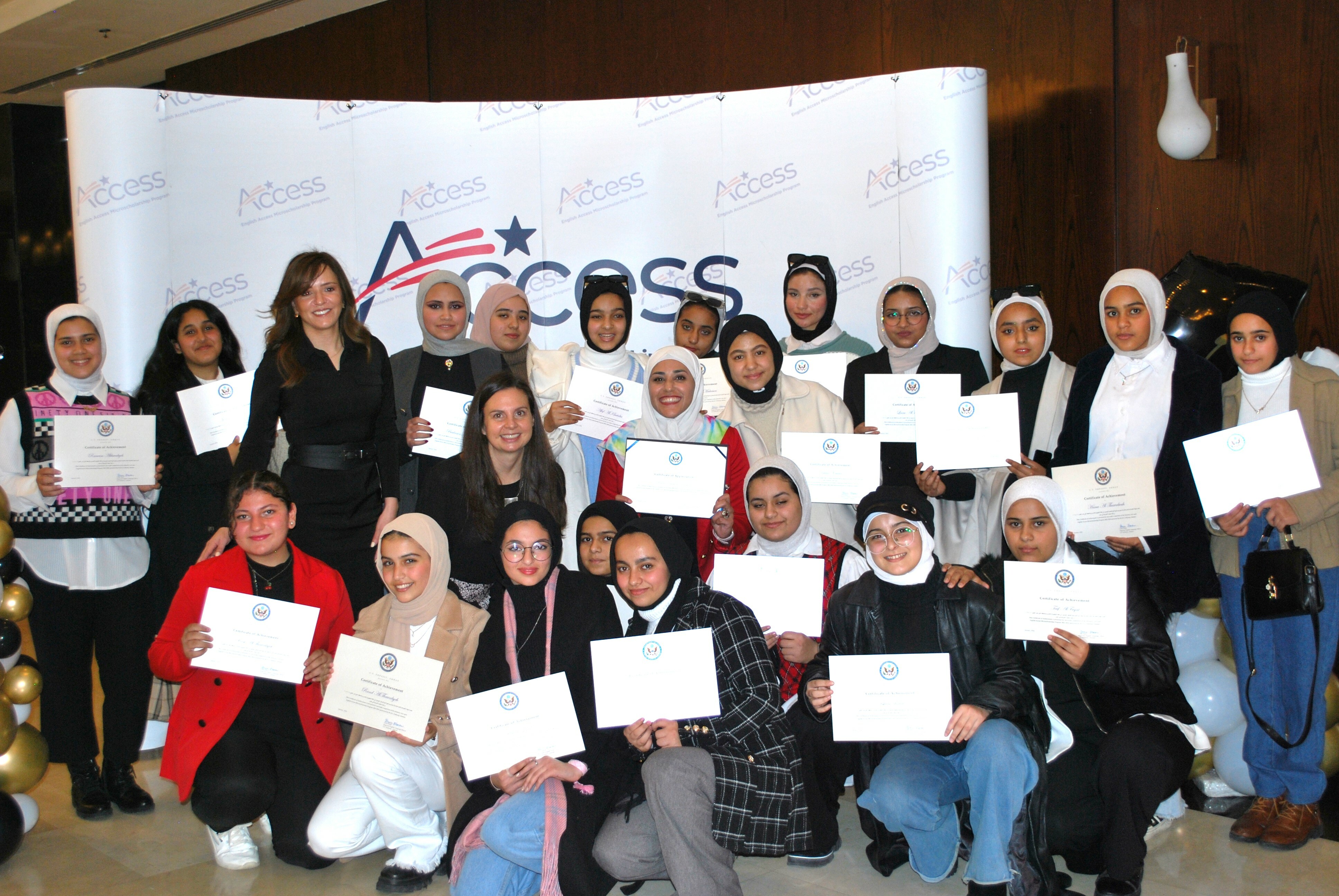 A large group of young women holding certificates