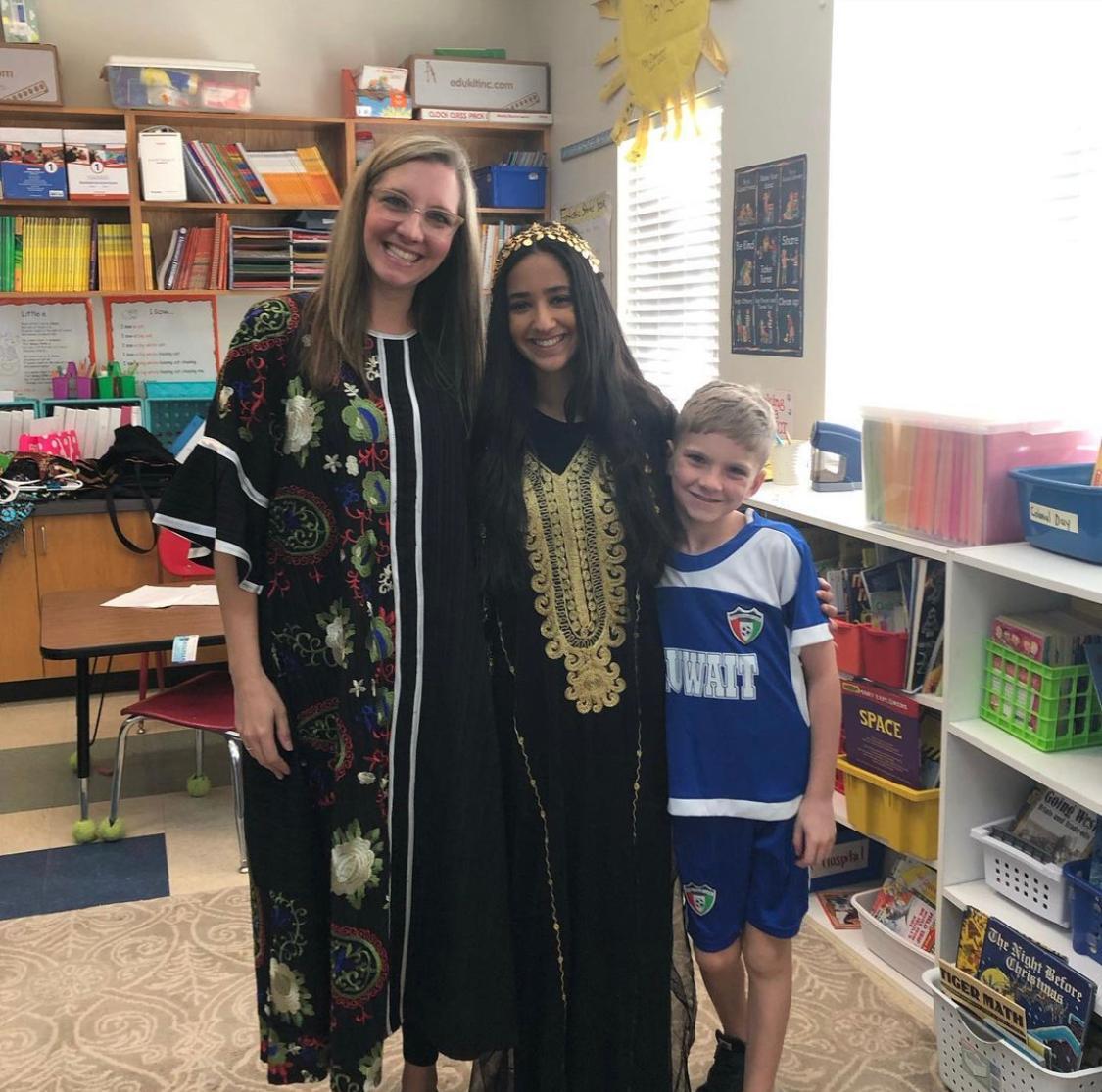 Ruby with her host family wearing traditional Kuwaiti clothes