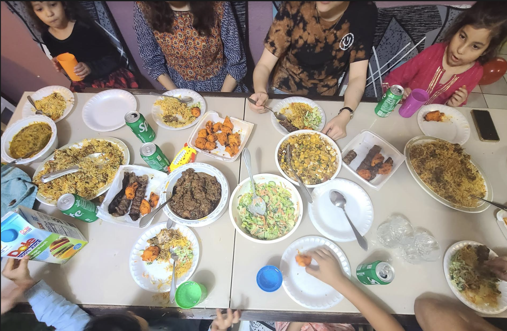 Wareesha and her host family eating Pakistani food.