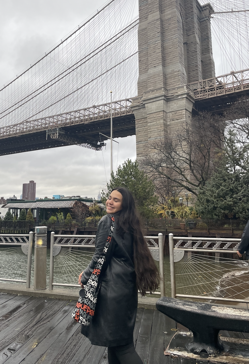 YES student, Hina standing in front of the Brooklyn Bridge.