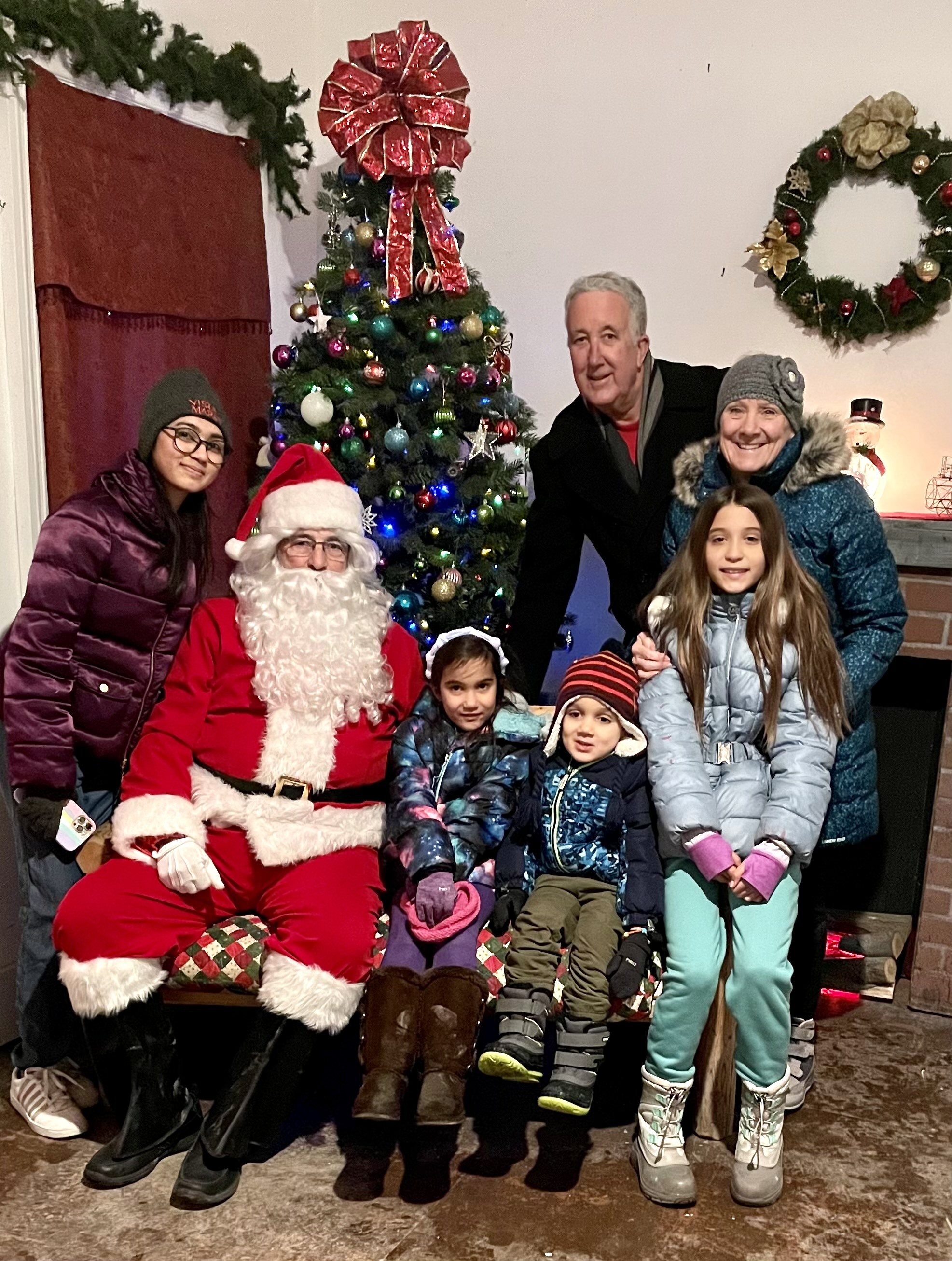 Sereena and her host family posing with Santa