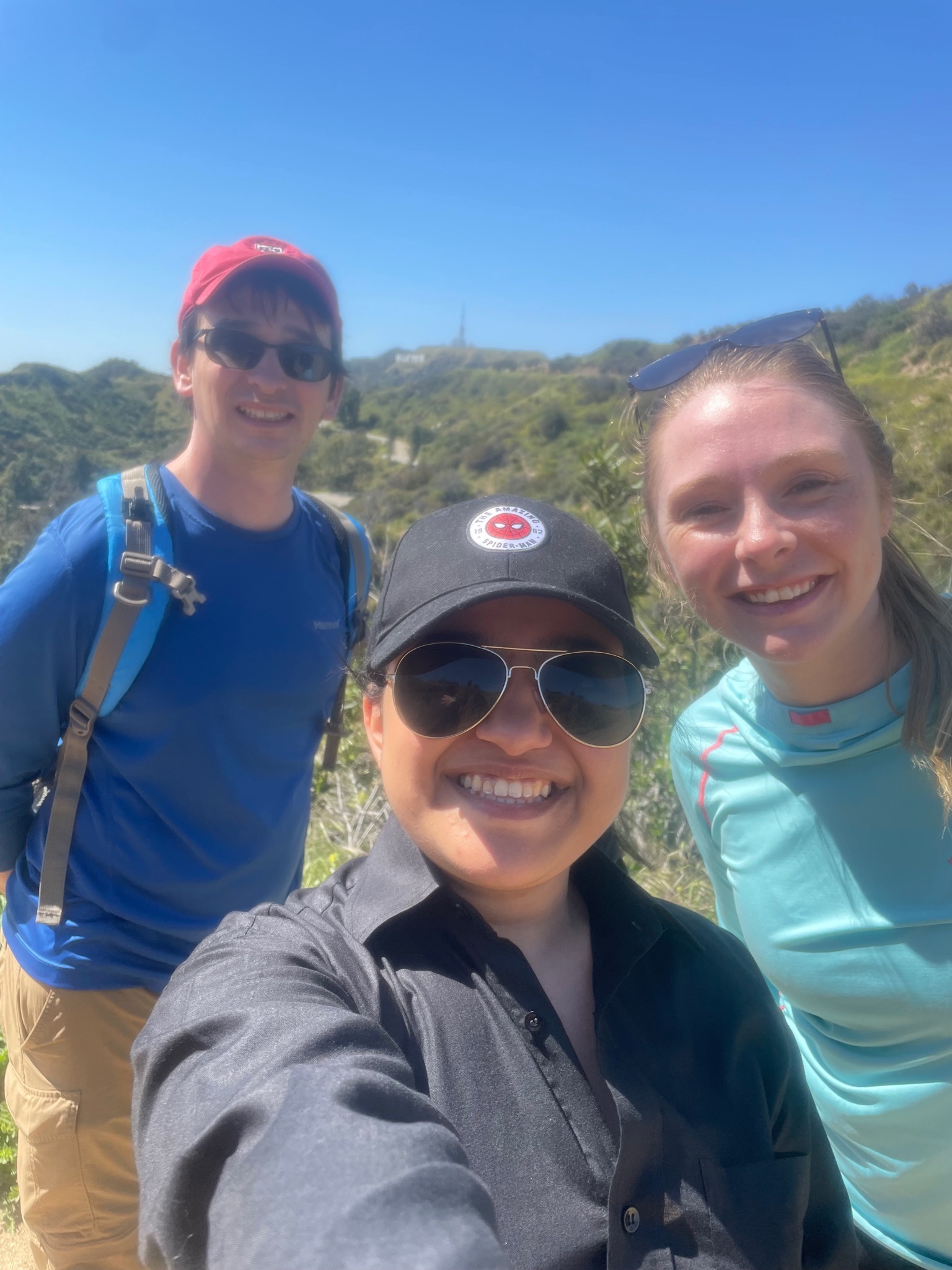 Student Posing With Two Others On A Hike